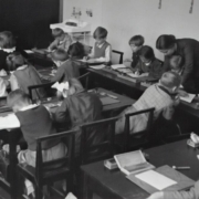 A vintage primary-school classroom scene in black & white